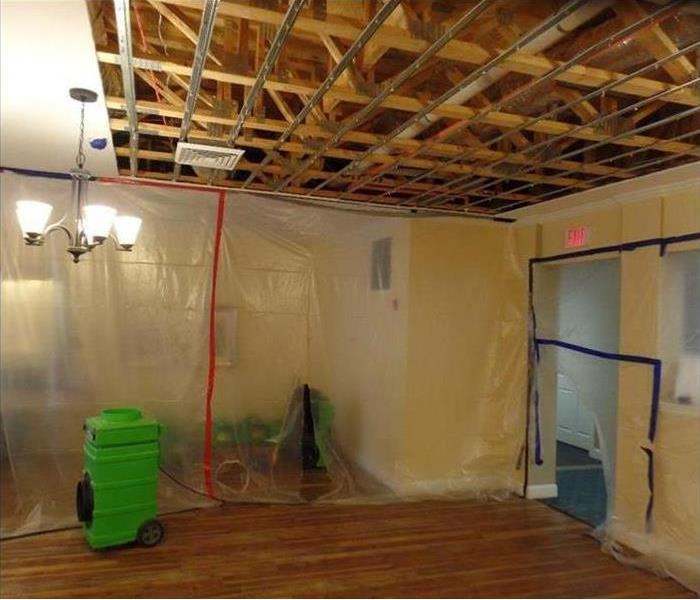 removed ceiling showing framing, plastic poly sheeting and equipment