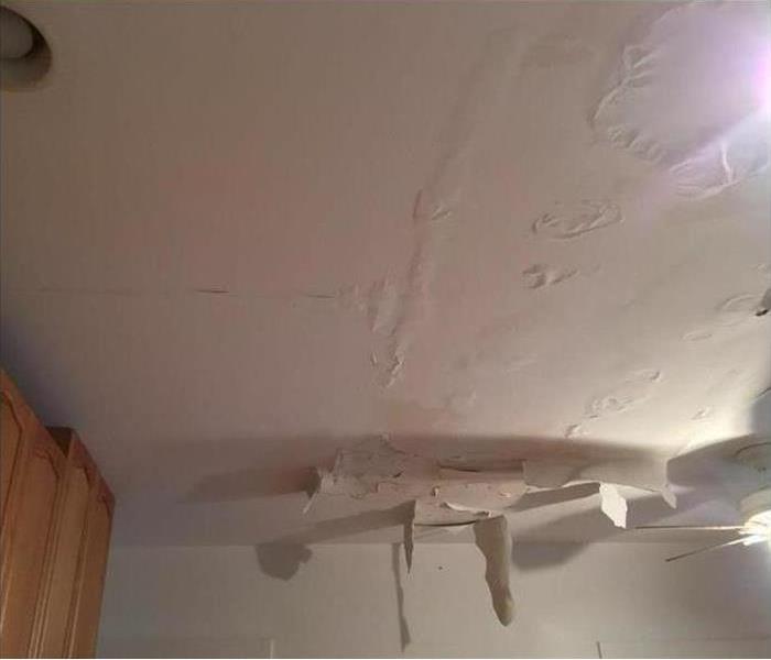 hanging debris from a wet ceiling in a kitchen