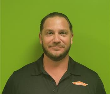 male employee with a beard wearing a black shirt