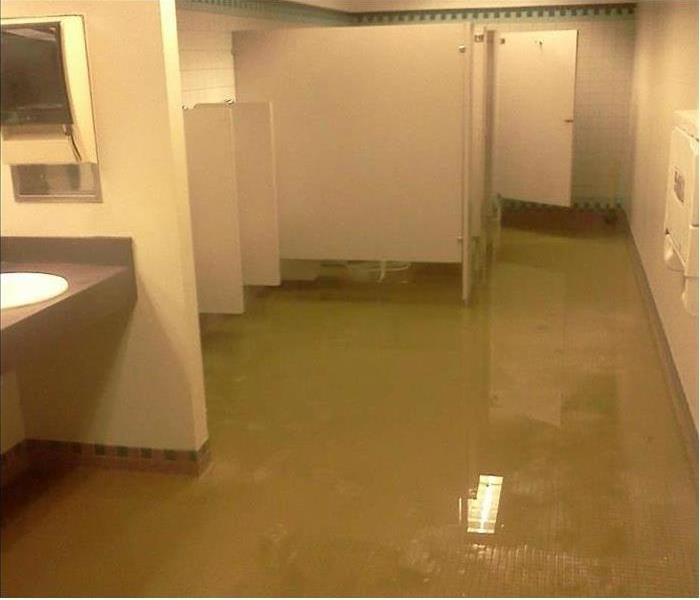 water covering tiled floor in a restroom