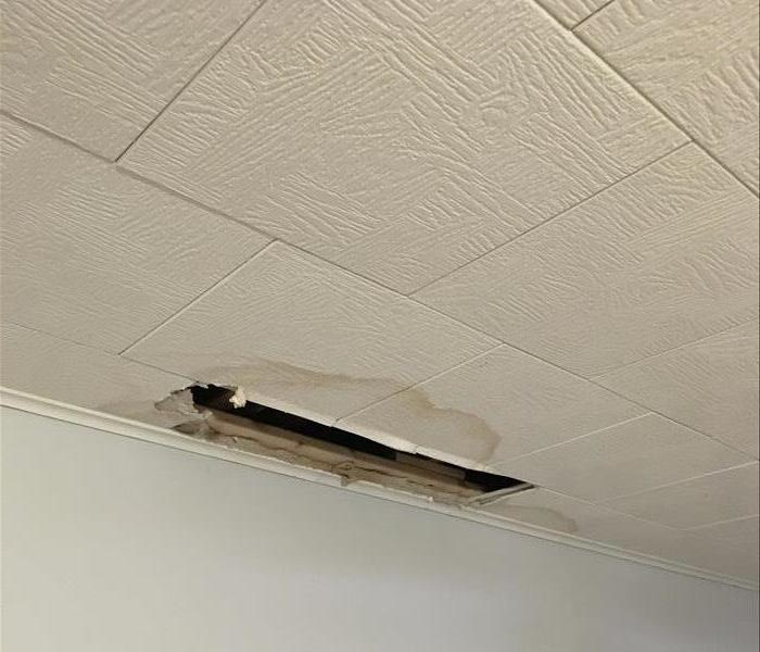 water damage, hole in ceiling by the wall